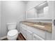 Bathroom vanity with granite countertop, white cabinetry, and a large mirror at 2923 Se 14Th St, Ocala, FL 34471