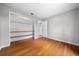 Neutral bedroom featuring hardwood floors and an open closet with built-in shelving at 2923 Se 14Th St, Ocala, FL 34471