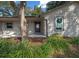 Inviting front entrance featuring a decorative front door, stone accents, and lush landscaping at 2923 Se 14Th St, Ocala, FL 34471