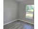 Bright bedroom with a window and wood-look laminate floors at 3373 Se 148Th Pl, Summerfield, FL 34491