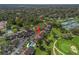 Aerial view of a community with a pool, golf course, tennis court, and ample parking at 3437 E Fort King St # 220, Ocala, FL 34470