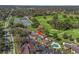 Aerial view of a property with a swimming pool, golf course, and tennis courts at 3437 E Fort King St # 220, Ocala, FL 34470