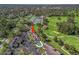 Aerial view of a property near a golf course with a swimming pool and tennis courts at 3437 E Fort King St # 220, Ocala, FL 34470