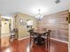 Formal dining room with wood floors, accent wall, and chandelier at 3437 E Fort King St # 220, Ocala, FL 34470