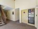 Condo hallway featuring stairway, carpeting, and door with decor at 3437 E Fort King St # 220, Ocala, FL 34470