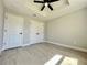 Minimalist bedroom with a ceiling fan, recessed lighting, and a double closet for storage at 3684 Se 130Th Pl, Belleview, FL 34420