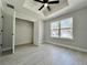 Bedroom with a walk-in closet, bright window, and wood-look flooring for a modern touch at 3684 Se 130Th Pl, Belleview, FL 34420