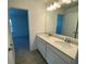 Bathroom featuring double sinks, quartz countertop and wood-look flooring at 3969 Ne 30Th Ter, Ocala, FL 34479