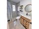 Modern bathroom with a tiled shower, floating shelves, and contemporary vanity at 4480 Ne 25Th Ave, Ocala, FL 34479