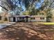 Charming single-story home featuring a brick facade, dark trim, and a well-maintained front lawn at 4480 Ne 25Th Ave, Ocala, FL 34479