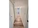 Hallway featuring white walls, modern flooring, and access to various rooms within the home at 4480 Ne 25Th Ave, Ocala, FL 34479