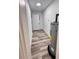 Hallway featuring white walls, modern flooring, and access to various rooms within the home at 4480 Ne 25Th Ave, Ocala, FL 34479