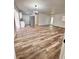 Inviting living room featuring wood floors, a chandelier and a seamless transition to the modern kitchen at 4480 Ne 25Th Ave, Ocala, FL 34479