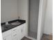 Bathroom showcasing a double vanity, black countertops, white cabinetry and walk-in shower at 46 Malauka Dr, Ocklawaha, FL 32179