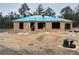 Exterior view of a house under construction with exposed studs and partially covered roof at 46 Malauka Dr, Ocklawaha, FL 32179