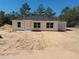 Charming single-story home featuring a cozy front porch and attached one car garage at 46 Malauka Dr, Ocklawaha, FL 32179