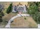 Aerial view of a beautiful white home with a manicured lawn and gardens, on a sunny day at 4620 Nw 84Th Ter, Ocala, FL 34482