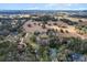 An aerial of a home on an expansive property featuring both landscaped areas and open fields under a clear sky at 4620 Nw 84Th Ter, Ocala, FL 34482