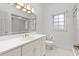 Bright bathroom with white vanity, gold fixtures, and tiled shower at 4620 Nw 84Th Ter, Ocala, FL 34482