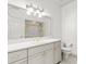 Bright bathroom featuring a vanity with modern fixtures and a glass-enclosed shower at 4620 Nw 84Th Ter, Ocala, FL 34482