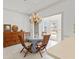 Charming dining area with a glass table, wooden chairs, and stylish chandelier at 4620 Nw 84Th Ter, Ocala, FL 34482