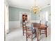 Charming dining room featuring a chandelier, patterned wallpaper, and classic furnishings at 4620 Nw 84Th Ter, Ocala, FL 34482