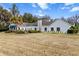 Rear exterior view of the house on its large lot with green awning at 4620 Nw 84Th Ter, Ocala, FL 34482