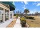 View of house featuring manicured lawn, brick patio, and mature trees at 4620 Nw 84Th Ter, Ocala, FL 34482