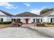 Classic white home with black shutters, brick accents, and manicured landscaping offers timeless curb appeal at 4620 Nw 84Th Ter, Ocala, FL 34482