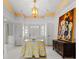 Bright foyer with white tile floors, chandelier, decorative table, and painting at 4620 Nw 84Th Ter, Ocala, FL 34482