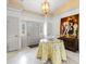 Bright foyer with white tile floors, chandelier, decorative table, and painting at 4620 Nw 84Th Ter, Ocala, FL 34482