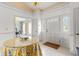 Bright foyer with white tile floors, chandelier, decorative table, and front door at 4620 Nw 84Th Ter, Ocala, FL 34482