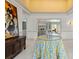 Bright foyer with white tile floors, decorative table, painting and view into the living room at 4620 Nw 84Th Ter, Ocala, FL 34482