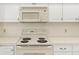 Close-up of the kitchen featuring an electric stove and white tiled backsplash at 4620 Nw 84Th Ter, Ocala, FL 34482