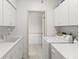 Laundry room featuring white cabinets, a sink, and a modern washing machine and dryer at 4620 Nw 84Th Ter, Ocala, FL 34482