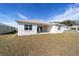 Exterior view of the backyard showing the covered patio and expansive lawn at 5589 Sw 78Th Ave Rd, Ocala, FL 34474