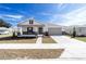 Inviting single-story home with a covered porch, manicured lawn, and a two-car garage at 5589 Sw 78Th Ave Rd, Ocala, FL 34474