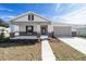 Desirable single-story home boasting a covered porch with stone detail and an attached two-car garage at 5589 Sw 78Th Ave Rd, Ocala, FL 34474