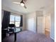 Bedroom with neutral carpet, ceiling fan, double closet, and bright window at 5898 Sw 116Th Street Rd, Ocala, FL 34476