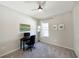 Minimalist bedroom with a desk, ceiling fan, neutral paint, carpet, and large window with natural light at 5898 Sw 116Th Street Rd, Ocala, FL 34476