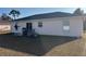 Exterior view of backyard featuring a covered patio area, a grill and sliding glass door at 61 Pecan Drive Loop, Ocala, FL 34472