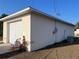 View of the home's side exterior and garage; includes utility box and A/C unit at 61 Pecan Drive Loop, Ocala, FL 34472