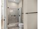 Modern bathroom featuring a glass enclosed shower with grey and white tiles and black fixtures at 6174 Spinnaker Loop, Lady Lake, FL 32159