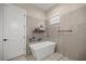 Modern bathroom features a soaking tub, window, and sleek fixtures at 6174 Spinnaker Loop, Lady Lake, FL 32159