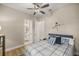 Comfortable bedroom has ceiling fan and en suite bath at 6174 Spinnaker Loop, Lady Lake, FL 32159