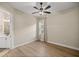 Neutral bedroom featuring hardwood floors, a ceiling fan, and a window that provides natural lighting at 6174 Spinnaker Loop, Lady Lake, FL 32159