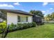 A lovely covered patio with a screened-in enclosure overlooks a lawn with manicured shrubs at 6174 Spinnaker Loop, Lady Lake, FL 32159