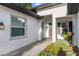 A welcoming front entry is accentuated by mature landscaping, covered porch, and craftsman details at 6174 Spinnaker Loop, Lady Lake, FL 32159