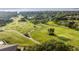 Scenic aerial shot of a lush golf course with manicured greens, rolling hills, and a water feature at 6174 Spinnaker Loop, Lady Lake, FL 32159