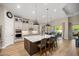 Spacious kitchen featuring a large island, modern pendant lighting, and stainless appliances at 6174 Spinnaker Loop, Lady Lake, FL 32159